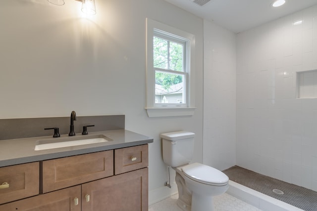 404 Williford Pl, Memphis, TN 38112 - full bath with toilet, a tile shower, vanity, tile patterned floors, and baseboards