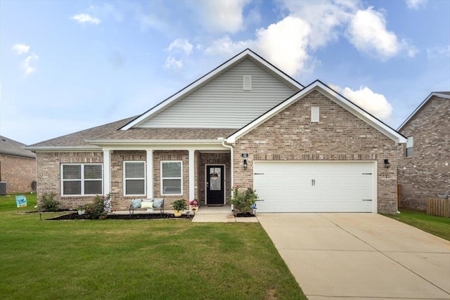 52 Twin Lakes Dr, Byhalia, MS 38611 - view of front of property with brick siding, concrete driveway, a front yard, a garage, and a shingled roof