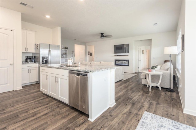 52 Twin Lakes Dr, Byhalia, MS 38611 - kitchen with appliances with stainless steel finishes, a sink, open floor plan, white cabinetry, and dark wood finished floors