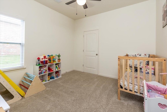 52 Twin Lakes Dr, Byhalia, MS 38611 - carpeted bedroom with multiple windows, a crib, and a ceiling fan