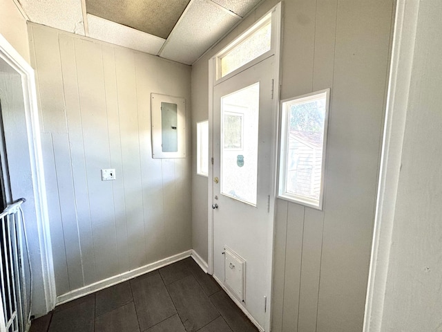 260 N Willett St, Memphis, TN 38112 - doorway to outside with electric panel, baseboards, a paneled ceiling, and dark tile patterned flooring