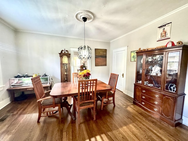 260 N Willett St, Memphis, TN 38112 - dining room with dark wood-type flooring, baseboards, and crown molding