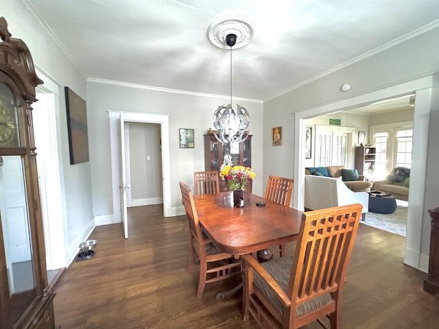 260 N Willett St, Memphis, TN 38112 - dining area with dark wood-style flooring, crown molding, a chandelier, and baseboards