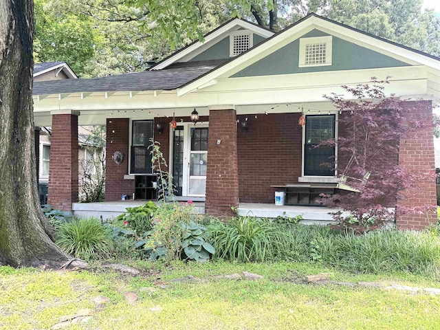 260 N Willett St, Memphis, TN 38112 - view of front of home featuring a porch, brick siding, and a shingled roof