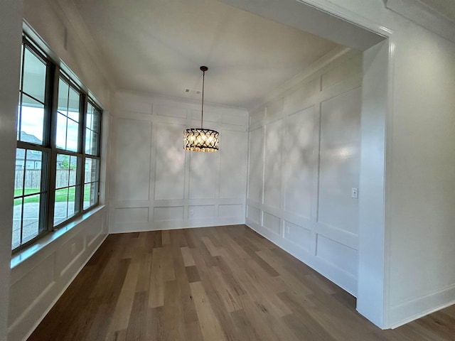 602 Cedar Shadows Cir W, Collierville, TN 38017 - unfurnished dining area with a decorative wall, wood finished floors, a chandelier, and ornamental molding
