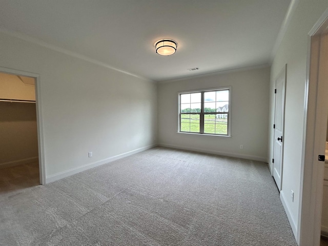 602 Cedar Shadows Cir W, Collierville, TN 38017 - unfurnished bedroom with ornamental molding, carpet floors, baseboards, and a walk in closet