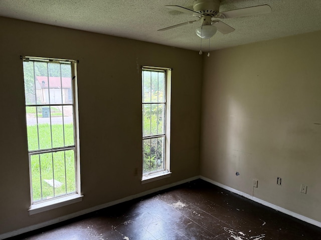 3701 Dorado Cv, Memphis, TN 38128 - spare room featuring baseboards, a textured ceiling, and a ceiling fan