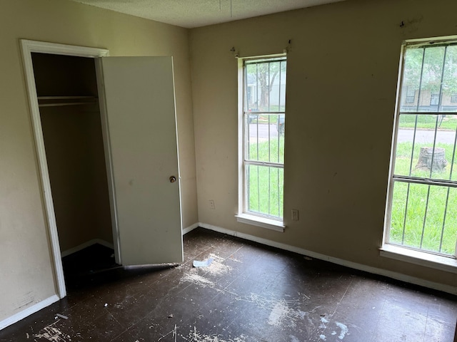 3701 Dorado Cv, Memphis, TN 38128 - unfurnished bedroom with multiple windows, baseboards, and a closet