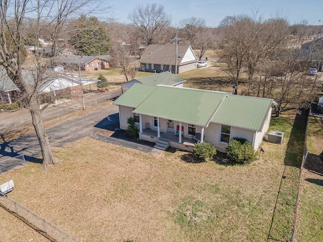 45 Daniel St, Savannah, TN 38372 - view of front of house with a porch, metal roof, central air condition unit, and brick siding