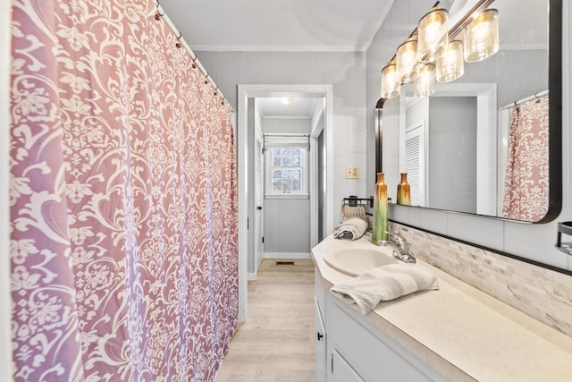 45 Daniel St, Savannah, TN 38372 - full bathroom with crown molding, vanity, wood finished floors, and baseboards
