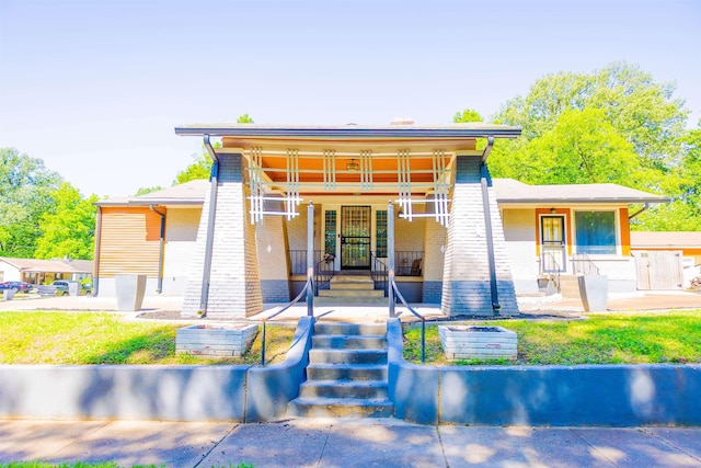 431 N Holmes St, Memphis, TN 38112 - view of front of house with covered porch and brick siding