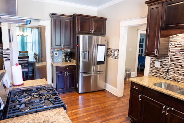 431 N Holmes St, Memphis, TN 38112 - kitchen featuring stainless steel refrigerator with ice dispenser, gas range oven, ornamental molding, tasteful backsplash, and light stone countertops