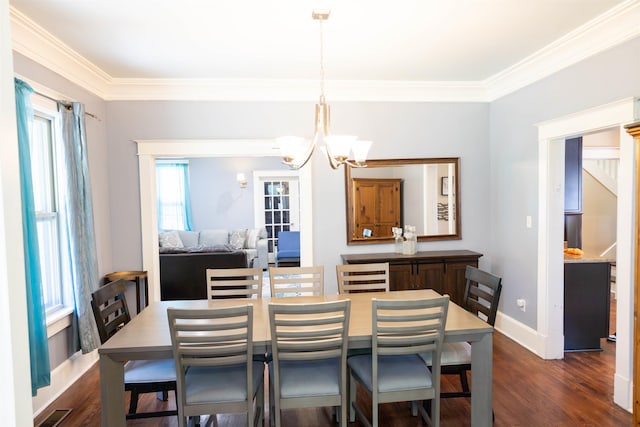 431 N Holmes St, Memphis, TN 38112 - dining space featuring a chandelier, crown molding, dark wood-style floors, and baseboards