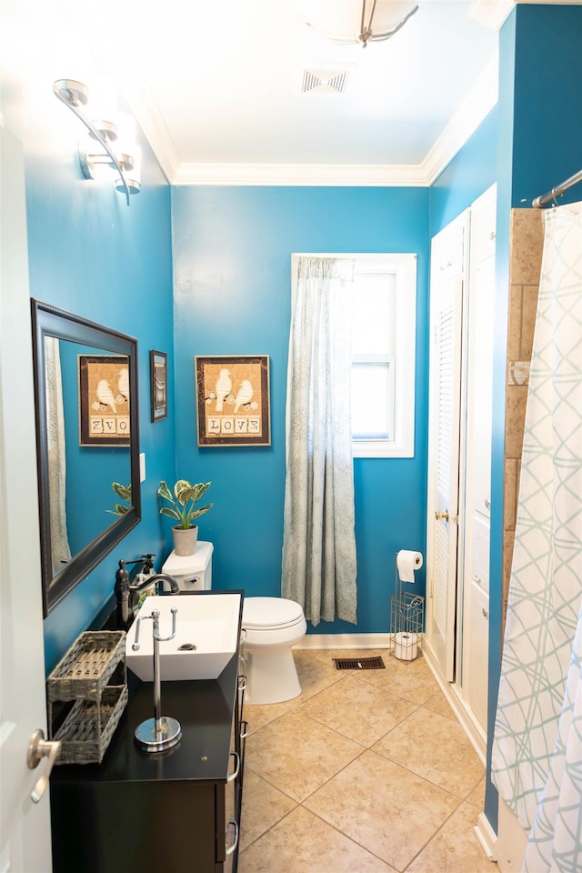 431 N Holmes St, Memphis, TN 38112 - bathroom with vanity, toilet, ornamental molding, tile patterned flooring, and a shower with shower curtain