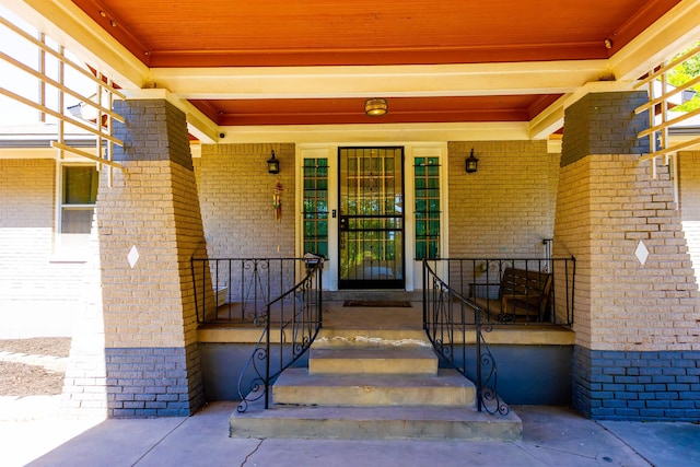 431 N Holmes St, Memphis, TN 38112 - view of exterior entry featuring brick siding and covered porch