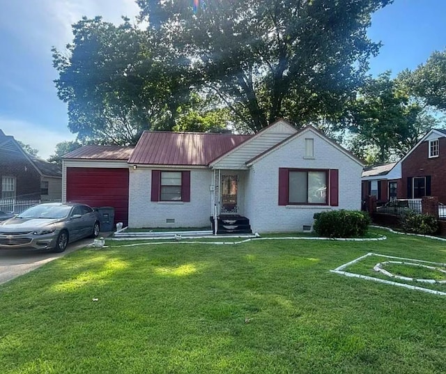 931 Maxey St, Memphis, TN 38111 - view of front of property featuring a garage, brick siding, a front lawn, metal roof, and concrete driveway
