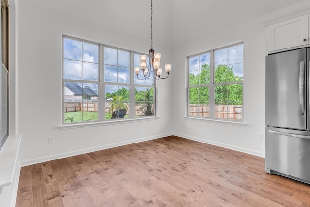 45 Laurel Hedge Cv, Oakland, TN 38060 - unfurnished dining area featuring a chandelier, light wood-style flooring, and baseboards