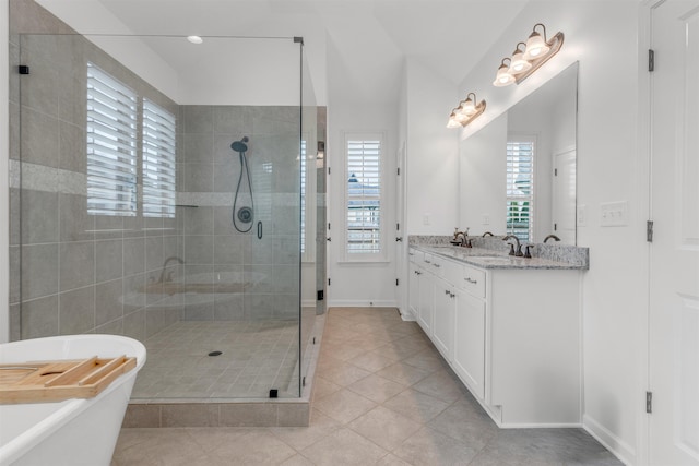 45 Laurel Hedge Cv, Oakland, TN 38060 - bathroom featuring tile patterned flooring, a shower stall, a freestanding tub, double vanity, and healthy amount of natural light
