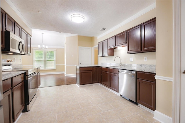 4386 S Germantown Rd, Memphis, TN 38125 - kitchen featuring appliances with stainless steel finishes, a sink, dark brown cabinetry, a textured ceiling, and a peninsula