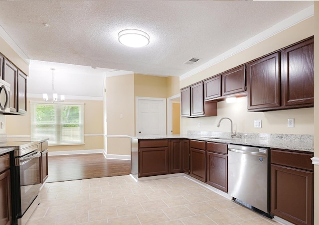 4386 S Germantown Rd, Memphis, TN 38125 - kitchen with appliances with stainless steel finishes, a sink, dark brown cabinets, a textured ceiling, and a peninsula