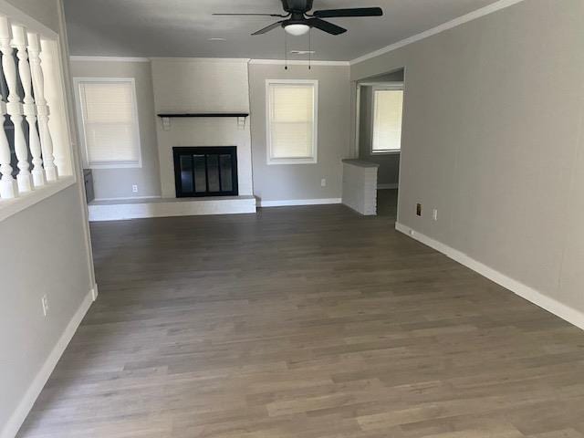 4947 Demeter Cv, Memphis, TN 38118 - unfurnished living room featuring a ceiling fan, baseboards, crown molding, a brick fireplace, and wood finished floors