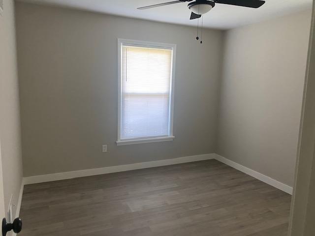 4947 Demeter Cv, Memphis, TN 38118 - spare room featuring a ceiling fan, wood finished floors, and baseboards