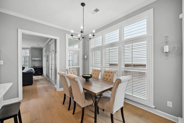 142 Granehampton Ln, Memphis, TN 38111 - dining area featuring ornamental molding, a chandelier, light wood-type flooring, french doors, and baseboards