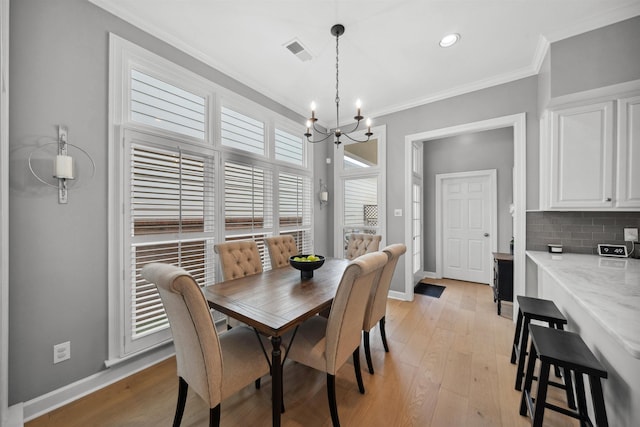 142 Granehampton Ln, Memphis, TN 38111 - dining area with a chandelier, ornamental molding, baseboards, light wood-style floors, and recessed lighting