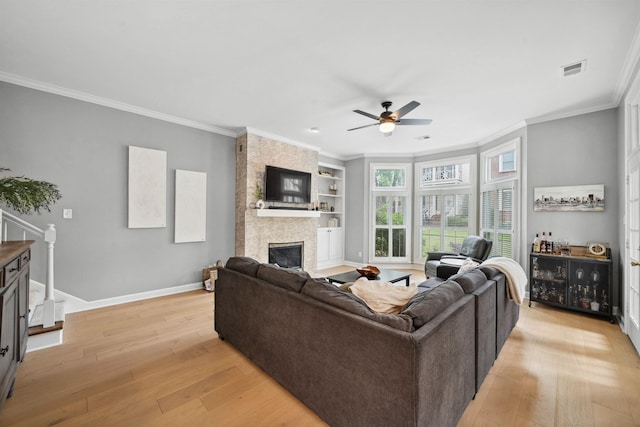 142 Granehampton Ln, Memphis, TN 38111 - living room featuring a large fireplace, light wood-style flooring, ornamental molding, ceiling fan, and baseboards