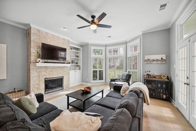 142 Granehampton Ln, Memphis, TN 38111 - living room with wood finished floors, a ceiling fan, built in shelves, a large fireplace, and ornamental molding