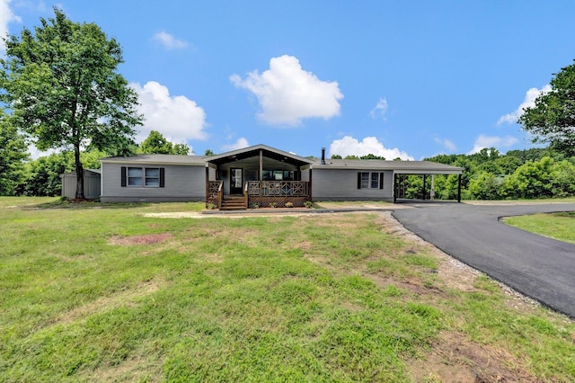 229 Coats Rd, Brighton, TN 38011 - view of front of home featuring covered porch, an attached carport, a front yard, and asphalt driveway