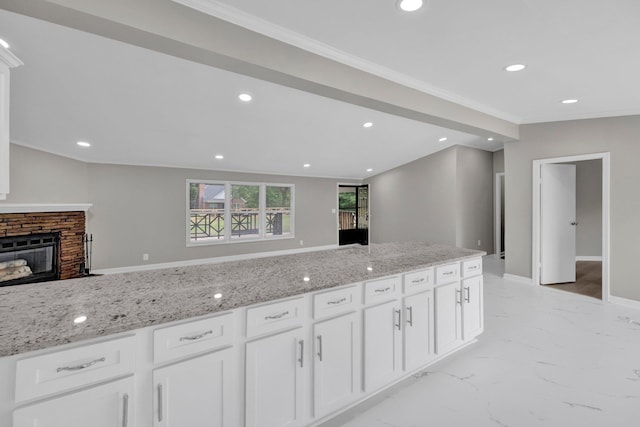 229 Coats Rd, Brighton, TN 38011 - kitchen featuring light stone countertops, white cabinets, ornamental molding, light marble finish flooring, and a fireplace