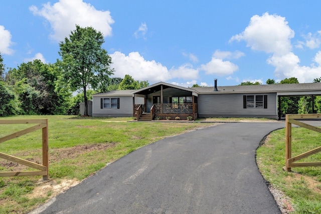 229 Coats Rd, Brighton, TN 38011 - manufactured / mobile home with covered porch, a front lawn, and asphalt driveway