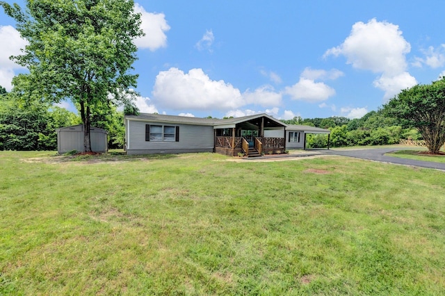 229 Coats Rd, Brighton, TN 38011 - view of front of home with driveway, covered porch, a front yard, and an attached carport