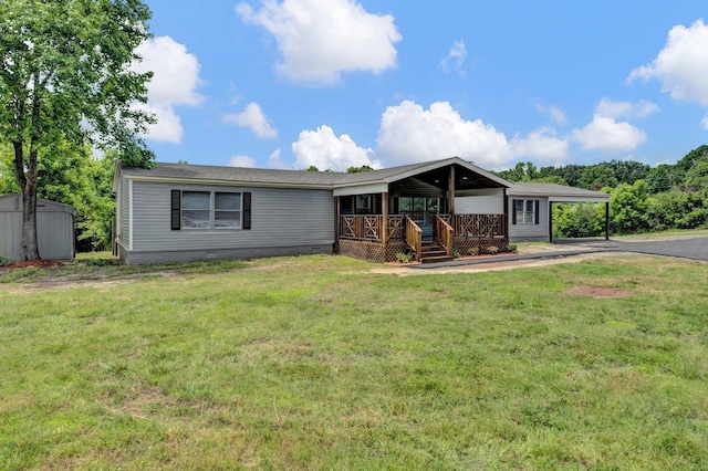 229 Coats Rd, Brighton, TN 38011 - manufactured / mobile home with driveway, a porch, a front lawn, a carport, and crawl space