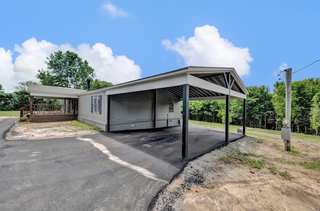 229 Coats Rd, Brighton, TN 38011 - view of parking / parking lot featuring an attached carport and asphalt driveway