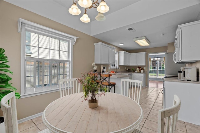 9270 Durhamshire Dr, Cordova, TN 38016 - dining space with a chandelier, light tile patterned floors, and baseboards