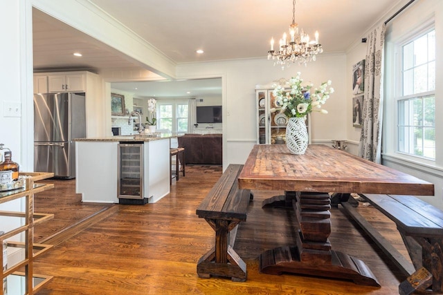 241 Greenway Rd, Memphis, TN 38117 - dining room featuring beverage cooler, dark wood-style flooring, crown molding, a chandelier, and recessed lighting