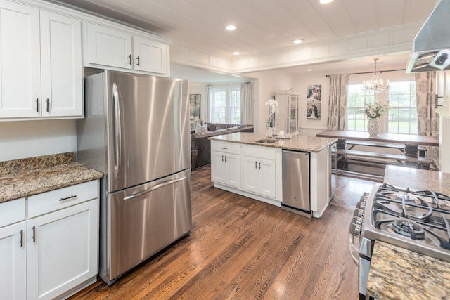 241 Greenway Rd, Memphis, TN 38117 - kitchen featuring stainless steel appliances, dark wood-style floors, wall chimney exhaust hood, white cabinetry, and ornamental molding
