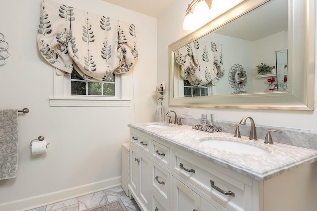 241 Greenway Rd, Memphis, TN 38117 - bathroom with baseboards, double vanity, and marble look tiles