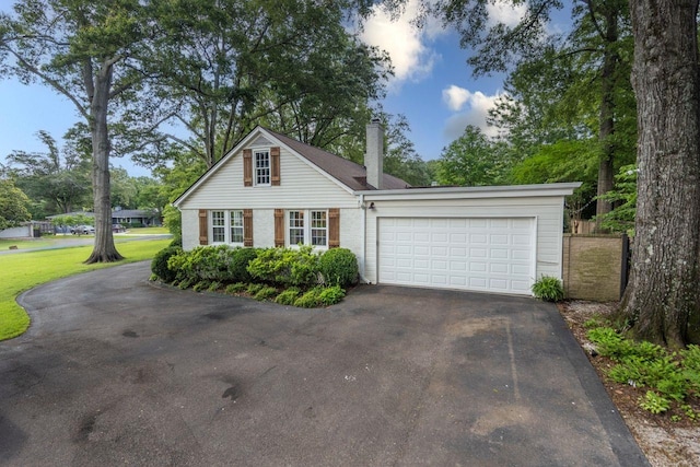 241 Greenway Rd, Memphis, TN 38117 - view of front of property featuring asphalt driveway, a chimney, a garage, and brick siding