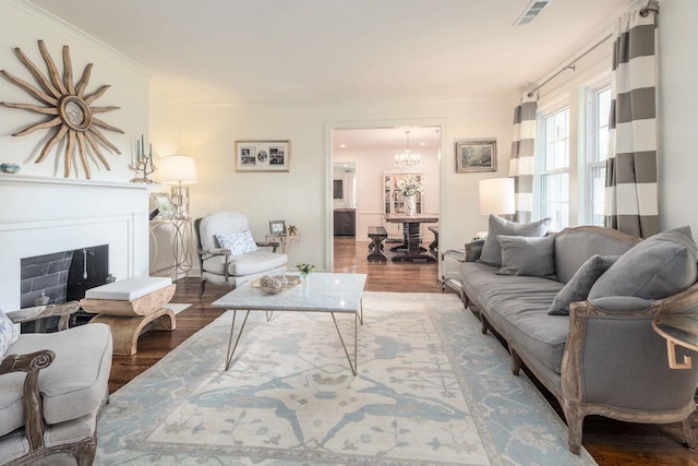 241 Greenway Rd, Memphis, TN 38117 - living area with a fireplace, wood finished floors, and a chandelier