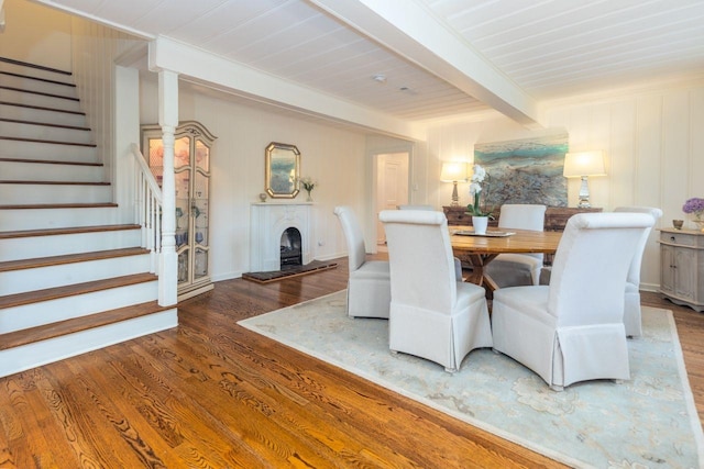 241 Greenway Rd, Memphis, TN 38117 - dining room featuring wood finished floors, stairway, beamed ceiling, and a fireplace with raised hearth