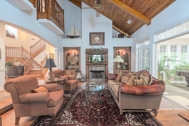 12821 Whispering Pines Dr, Olive Branch, MS 38654 - living room featuring high vaulted ceiling, stairway, a fireplace, arched walkways, and wood ceiling with exposed beams