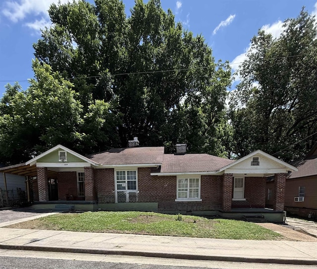 1432 Leland St, Memphis, TN 38106 - ranch-style house with brick siding, covered porch, a carport, and a front lawn