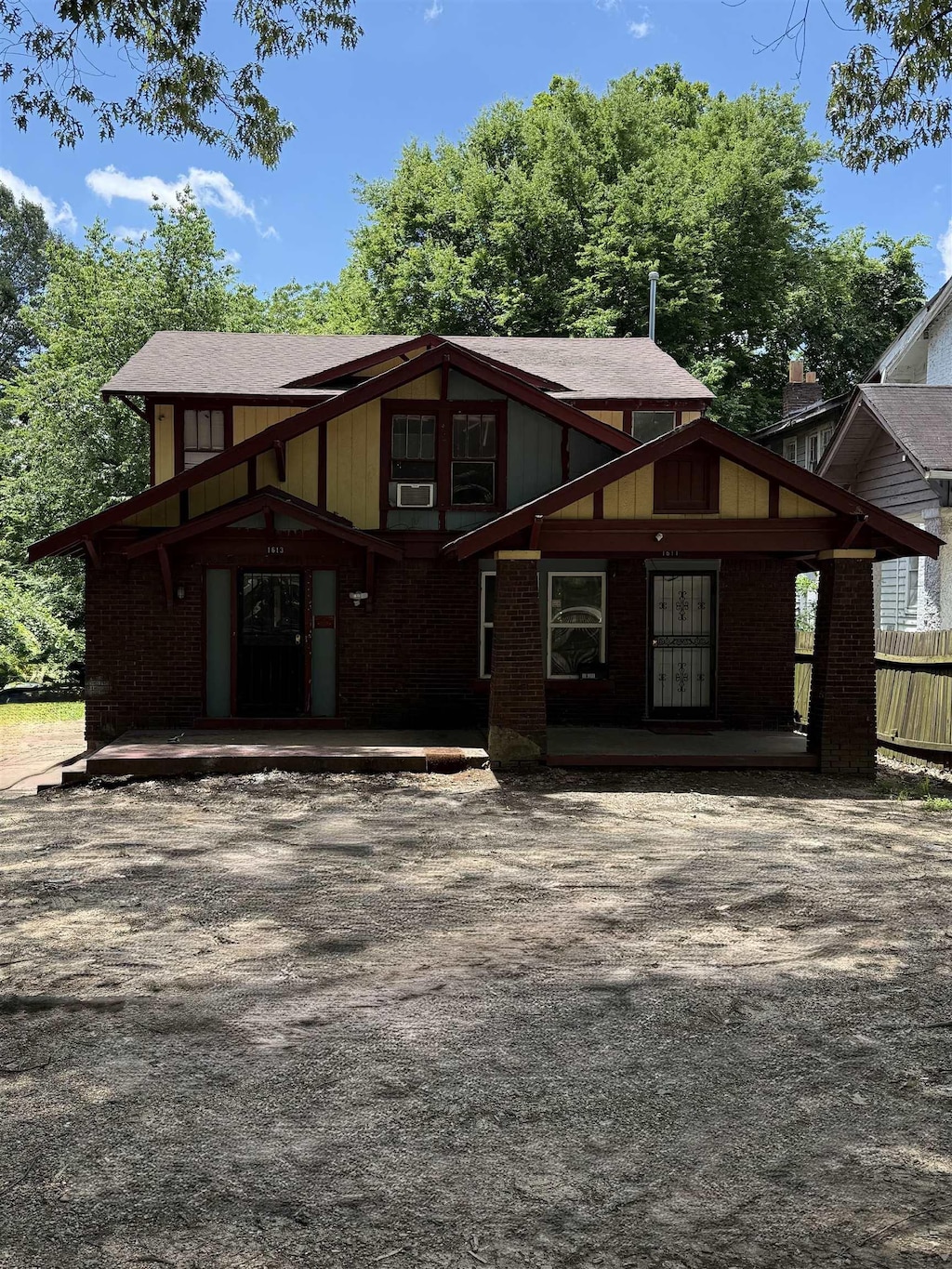 1611 S Parkway Ave S, Memphis, TN 38106 - tudor home with brick siding, cooling unit, and covered porch