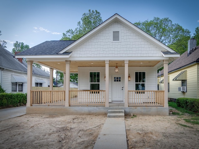 1742 Nelson Ave, Memphis, TN 38114 - view of front of house featuring covered porch, cooling unit, and roof with shingles