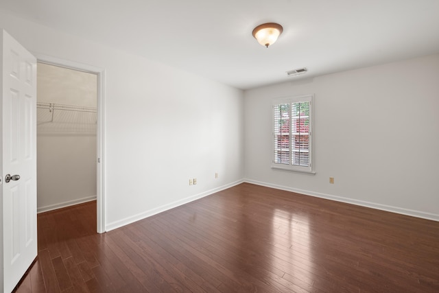 2073 W Houston Way, Collierville, TN 38139 - unfurnished bedroom with dark wood-style flooring, a walk in closet, baseboards, and a closet