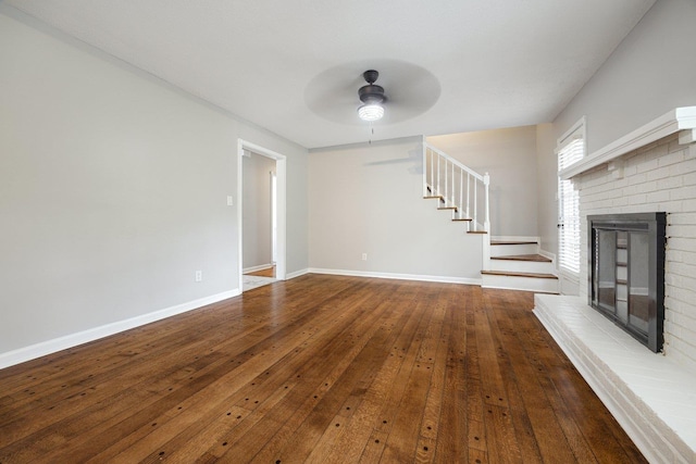 5236 Marynelle Cv, Memphis, TN 38116 - unfurnished living room with a brick fireplace, ceiling fan, stairway, and hardwood / wood-style floors