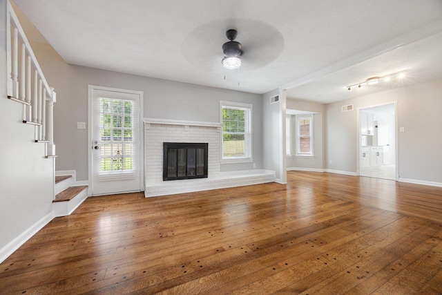 5236 Marynelle Cv, Memphis, TN 38116 - unfurnished living room with hardwood / wood-style floors, a ceiling fan, stairs, and baseboards